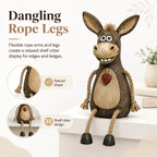 Rustic donkey figure on a plank with dangling rope legs